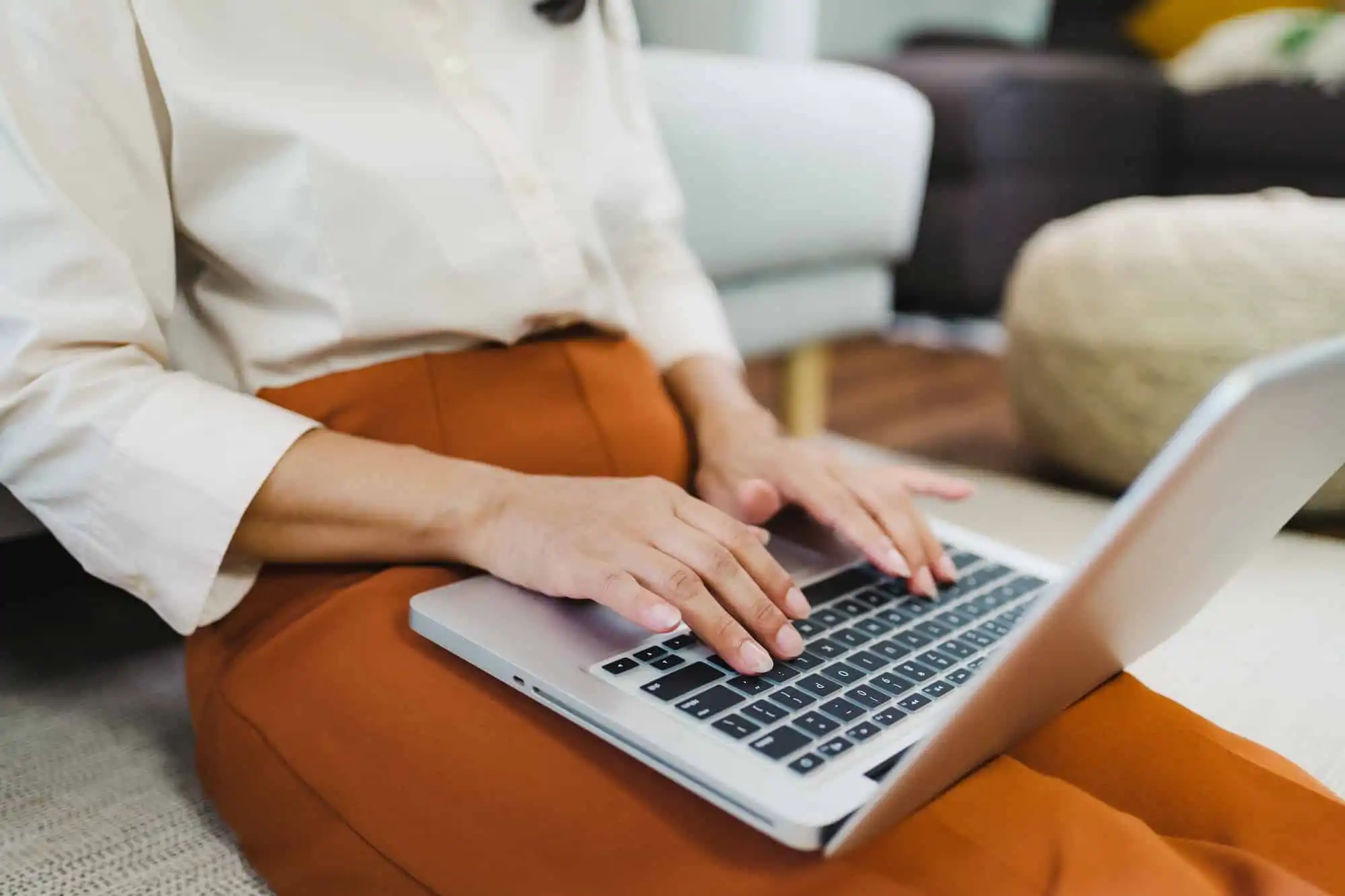 Working by using a laptop computer on wooden table. Hands typing on a keyboard.technology e-commerce