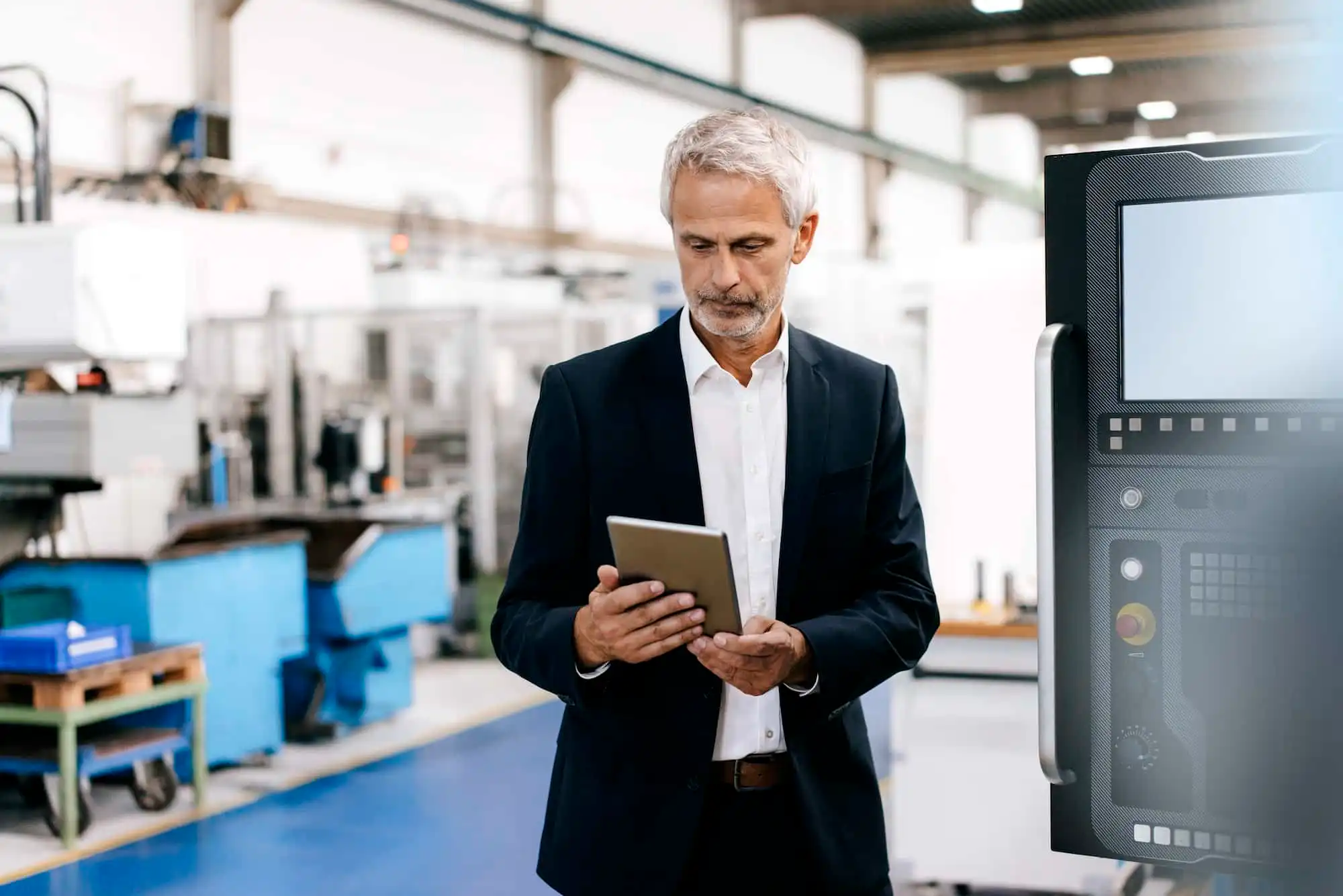 Manager using digital tablet in high tech company
